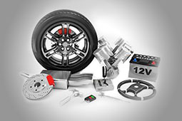 Assorted car parts including a wheel, brake disc and battery