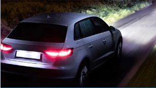 Hatchback with halogen headlights on at night